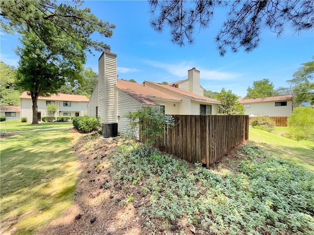1152 Country Ct, Lawrenceville, GA 30044 - view of home's exterior with a central AC unit and a chimney