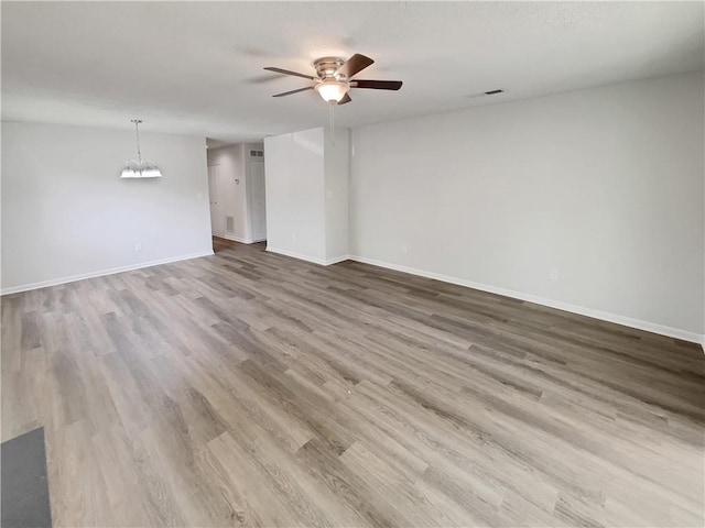 1152 Country Ct, Lawrenceville, GA 30044 - empty room with ceiling fan, wood finished floors, and a chandelier