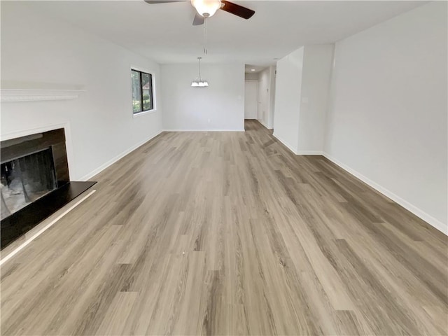 1152 Country Ct, Lawrenceville, GA 30044 - unfurnished living room with a ceiling fan, wood finished floors, and a fireplace with raised hearth