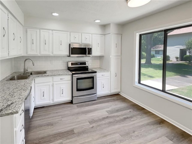 1152 Country Ct, Lawrenceville, GA 30044 - kitchen featuring appliances with stainless steel finishes, white cabinets, backsplash, and recessed lighting
