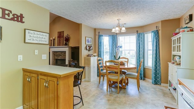 188 Crystal Creek Dr, Jasper, GA 30143 - dining area featuring a chandelier, a stone fireplace, and a textured ceiling