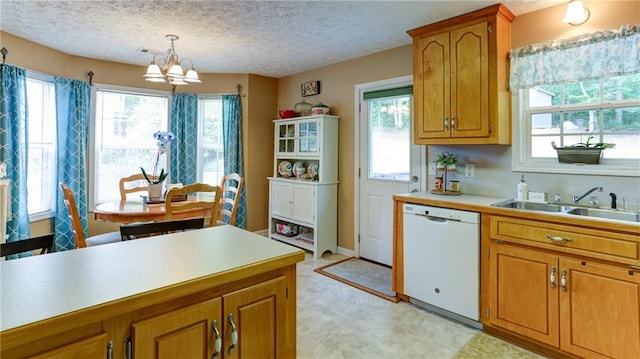 188 Crystal Creek Dr, Jasper, GA 30143 - kitchen with dishwasher, a chandelier, brown cabinets, light countertops, and healthy amount of natural light