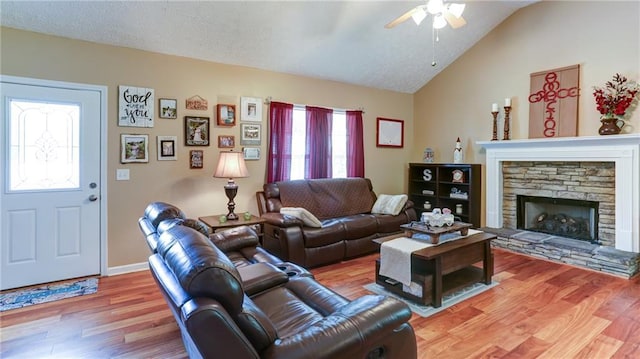 188 Crystal Creek Dr, Jasper, GA 30143 - living area featuring ceiling fan, wood finished floors, a fireplace, lofted ceiling, and a textured ceiling