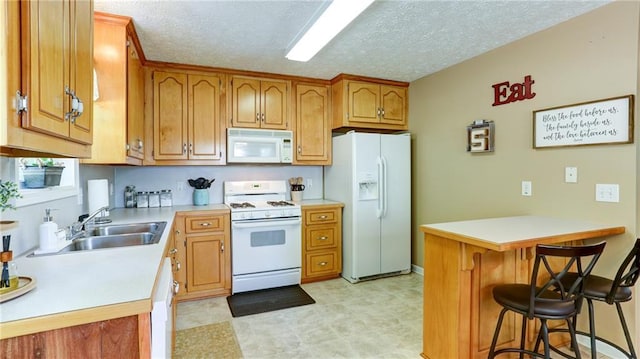 188 Crystal Creek Dr, Jasper, GA 30143 - kitchen with white appliances, a peninsula, a breakfast bar area, brown cabinetry, and light countertops