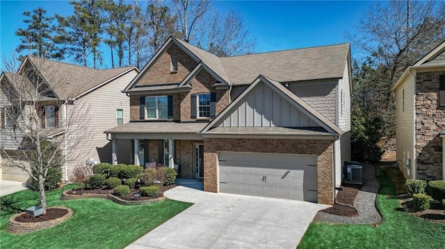 craftsman house featuring concrete driveway, an attached garage, board and batten siding, central AC, and a front lawn