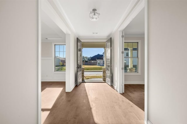 foyer entrance with baseboards, ornamental molding, and dark wood-style flooring