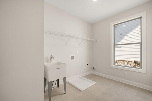 clothes washing area with laundry area, baseboards, washer hookup, light tile patterned floors, and hookup for an electric dryer