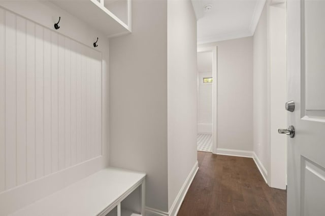 mudroom with baseboards, ornamental molding, and dark wood-style flooring