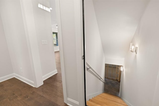stairs featuring baseboards and wood finished floors