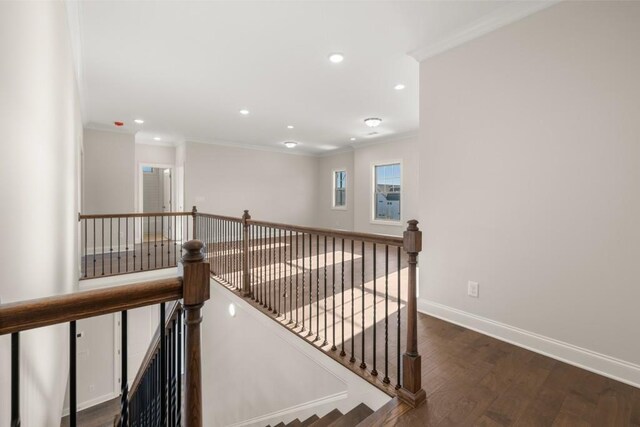 staircase featuring crown molding, recessed lighting, baseboards, and wood finished floors