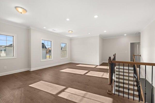 spare room featuring recessed lighting, plenty of natural light, ornamental molding, and wood finished floors