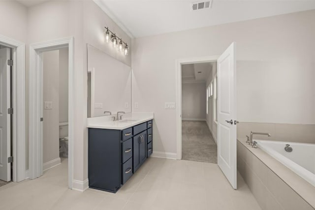 full bath featuring visible vents, vanity, toilet, baseboards, and a bath