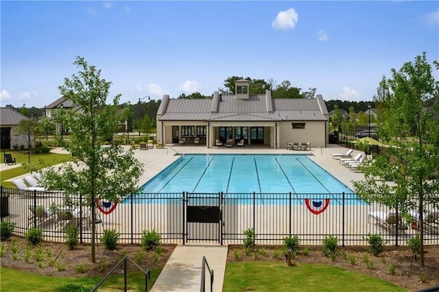 pool with a patio area and fence