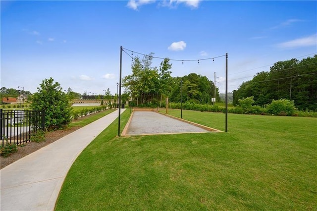 surrounding community with fence and a lawn