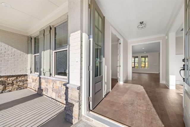 exterior space featuring a porch, stone siding, and brick siding