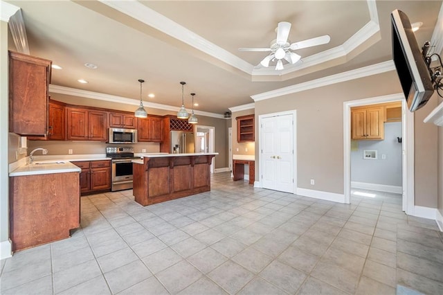 kitchen featuring a tray ceiling, stainless steel appliances, a center island, and crown molding