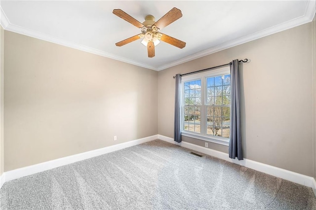 unfurnished room featuring carpet, crown molding, baseboards, and visible vents