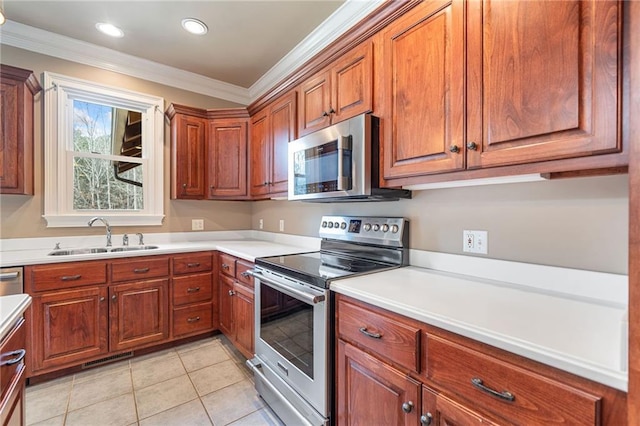 kitchen with light tile patterned floors, brown cabinetry, a sink, appliances with stainless steel finishes, and crown molding