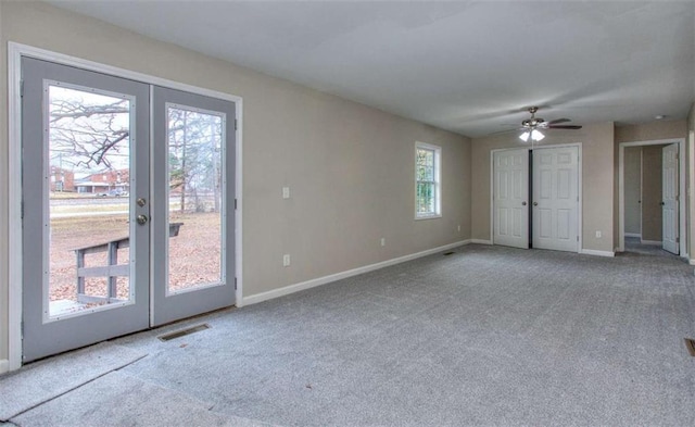 unfurnished room with carpet floors, ceiling fan, and french doors