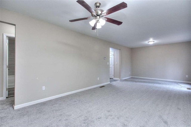 carpeted spare room with ceiling fan