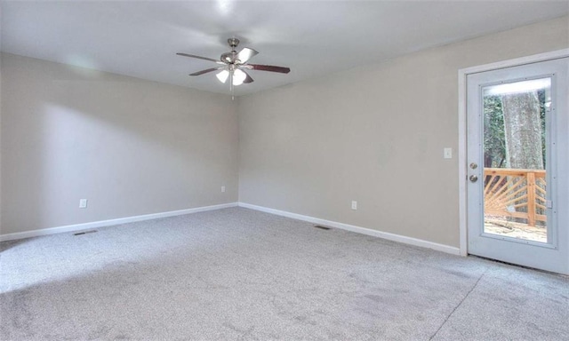 carpeted spare room with ceiling fan