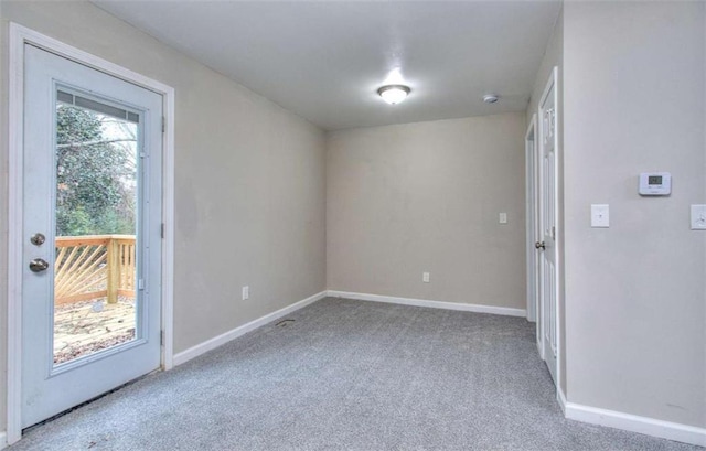 spare room featuring light colored carpet