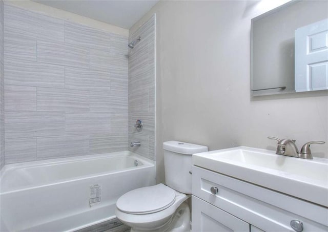 full bathroom with toilet, vanity, and tiled shower / bath