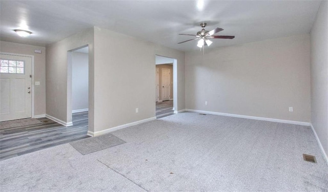 foyer entrance featuring ceiling fan and carpet floors