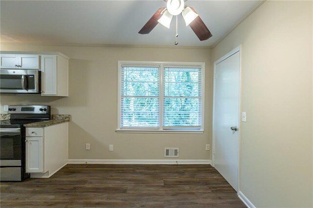 kitchen with white cabinets, appliances with stainless steel finishes, dark hardwood / wood-style floors, and crown molding