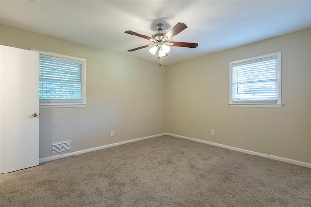 unfurnished room featuring light carpet and ceiling fan