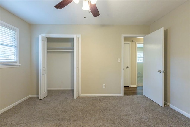 unfurnished bedroom featuring ceiling fan, a closet, and light carpet