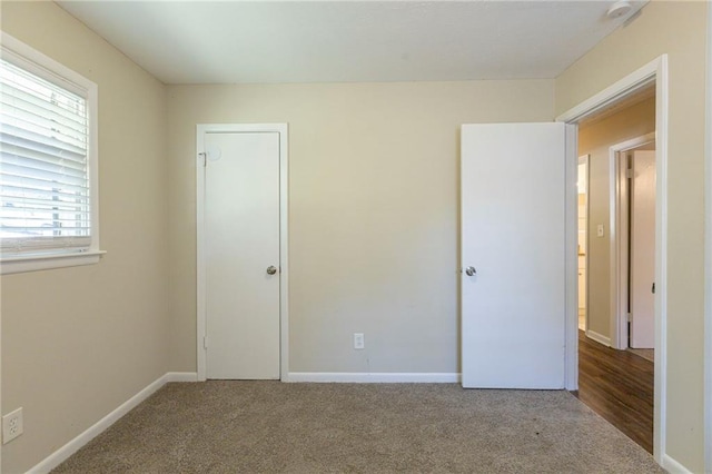 unfurnished bedroom with light carpet