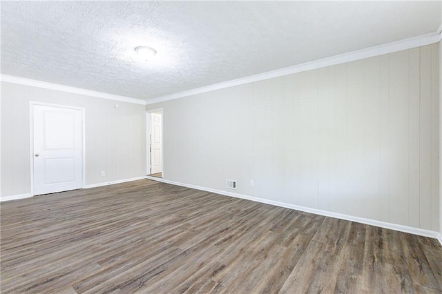 spare room featuring a textured ceiling, crown molding, and dark hardwood / wood-style flooring