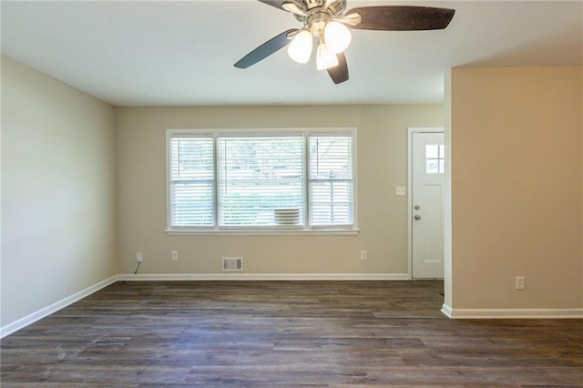 spare room with ceiling fan and dark hardwood / wood-style flooring