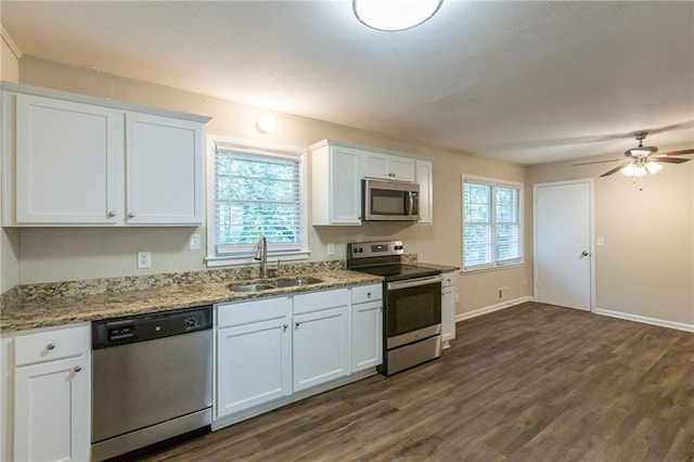 kitchen featuring appliances with stainless steel finishes, sink, a wealth of natural light, and white cabinetry