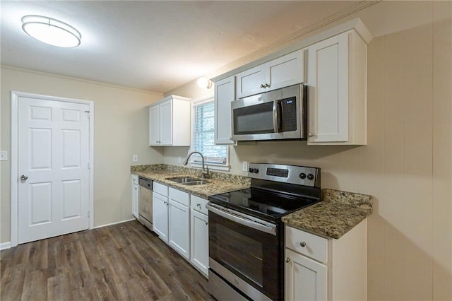 kitchen with dark hardwood / wood-style floors, sink, dark stone counters, white cabinetry, and appliances with stainless steel finishes