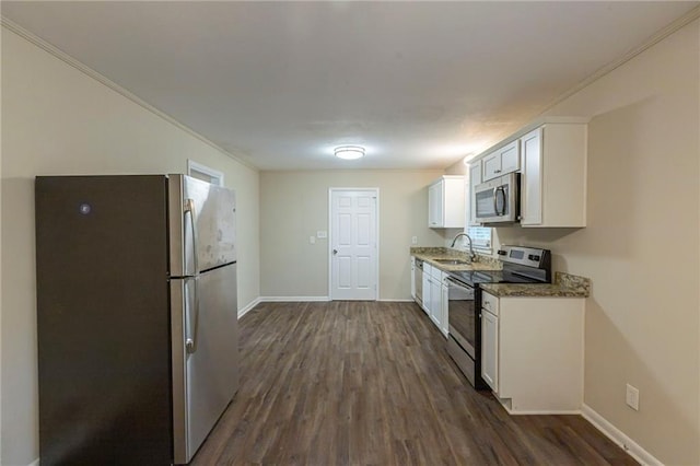 kitchen featuring dark stone counters, sink, stainless steel appliances, dark hardwood / wood-style floors, and white cabinets