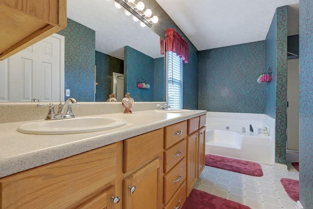 bathroom with double vanity, a sink, a bath, and wallpapered walls