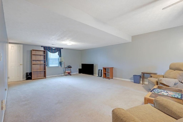 living room featuring a textured ceiling, light carpet, and baseboards