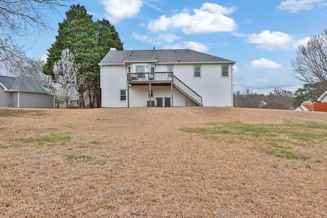 back of property featuring stairs, a lawn, and a wooden deck
