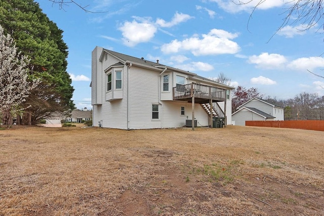 rear view of property featuring stairs, fence, a deck, a yard, and central air condition unit