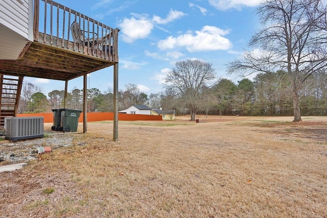 view of yard with stairs, central AC, and a deck