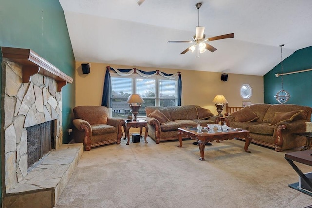 living room with lofted ceiling, carpet, ceiling fan, and a stone fireplace