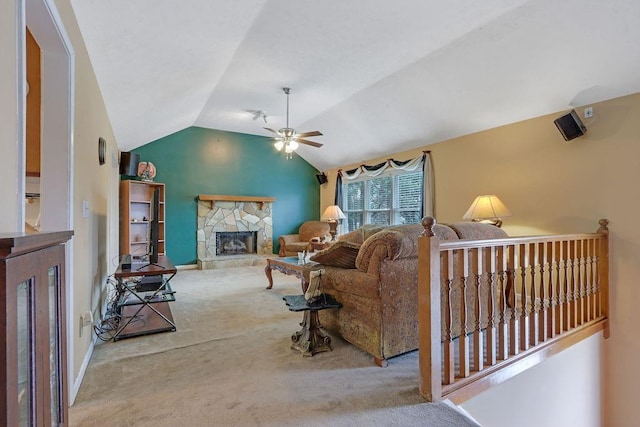 living area featuring ceiling fan, carpet floors, a fireplace, baseboards, and vaulted ceiling