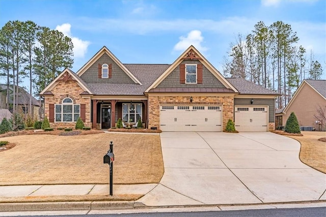 craftsman house with stone siding and concrete driveway