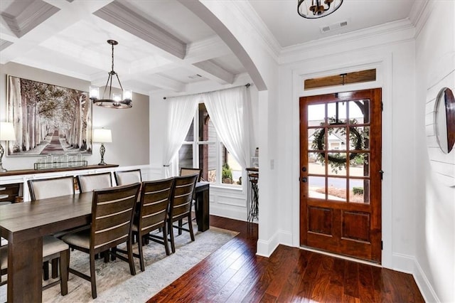 foyer with arched walkways, coffered ceiling, visible vents, beamed ceiling, and wood-type flooring