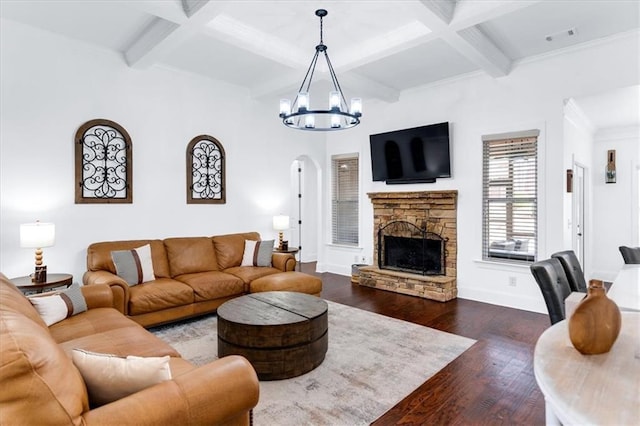 living area featuring a chandelier, dark wood-style flooring, coffered ceiling, and a fireplace