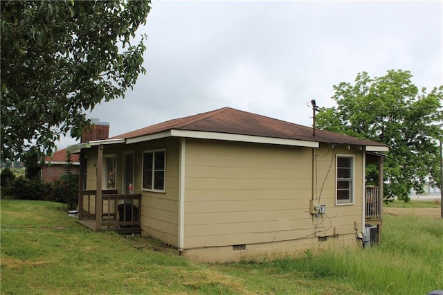 view of side of home featuring a lawn