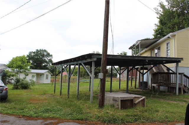 view of yard with an outdoor structure and a carport