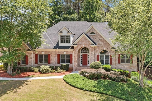 997 Thousand Oaks Bnd NW, Kennesaw, GA 30152 - traditional-style home with brick siding, a front yard, and a shingled roof